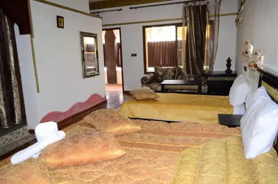 a bedroom with two beds with pillows on them at Maison d'hôtes Ambelar in Erfoud