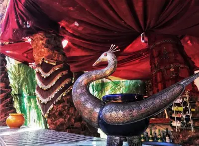 a statue of a dragon sitting on a table at Maison d'hôtes Ambelar in Erfoud