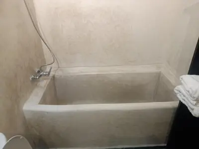 a white bath tub in a bathroom with a toilet at Ryad Naila Fes in Fès