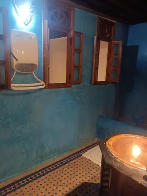 a bathroom with a sink and a toilet on the wall at Ryad Naila Fes in Fès