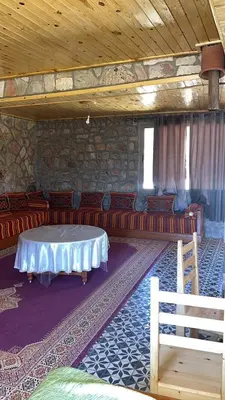 a room with a bed in the middle of a building at auberge panorama ouiouane in Kasba des Aït Athmane