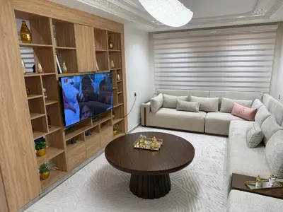 a living room with a couch and a table at villa bijoux in Oulad Akkou