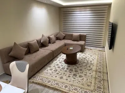 a living room with a couch and a table at villa bijoux in Oulad Akkou