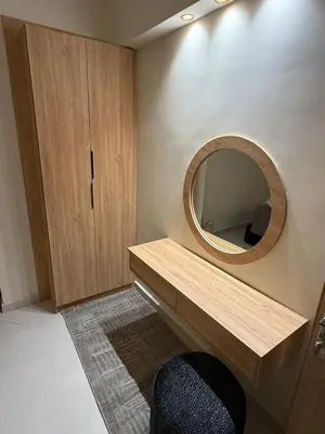 a bathroom with a vanity with a mirror and a chair at villa bijoux in Oulad Akkou