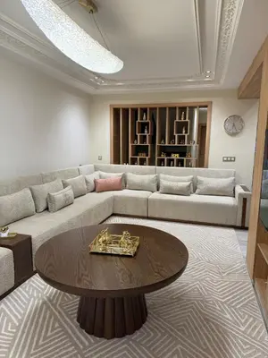 a living room with a couch and a table at villa bijoux in Oulad Akkou
