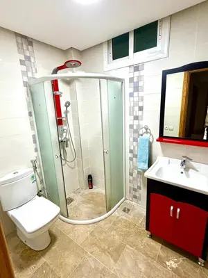 a bathroom with a shower and a toilet and a sink at Appartement centre ville avec Wifi 200 Mo in Fès