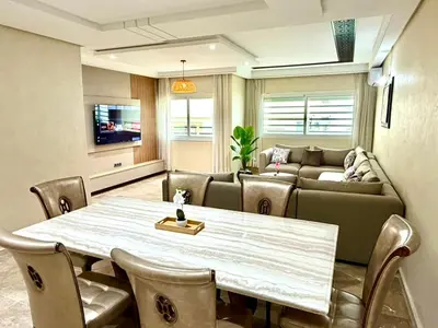a living room with a table and a couch at Appartement centre ville avec Wifi 200 Mo in Fès