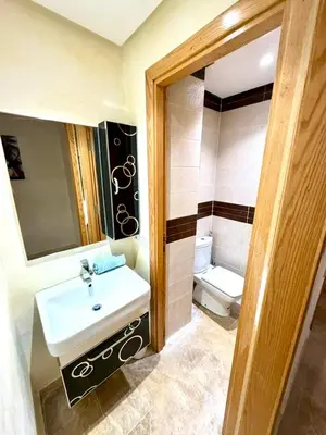a bathroom with a sink and a toilet at Appartement centre ville avec Wifi 200 Mo in Fès