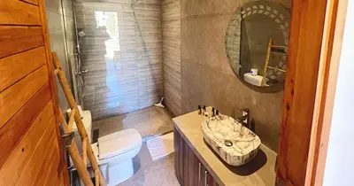 a bathroom with a sink and a toilet and a mirror at Maison d'Hotes Oasis Marrakech Route dOuarzazate in Oulad Akkou