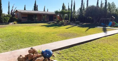 a yard with a house and a garden with a toy at Maison d'Hotes Oasis Marrakech Route dOuarzazate in Oulad Akkou