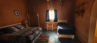 a bedroom with a bed and a window at Auberge Merzane in Merzane