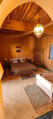 a bedroom with a bed and a chandelier at Auberge Merzane in Merzane