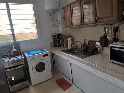 a kitchen with a washing machine and a sink at Les jardins d'Ifrane in Ifrane