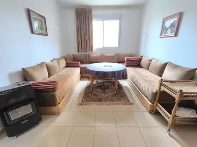 a living room with a couch and a table at Les jardins d'Ifrane in Ifrane