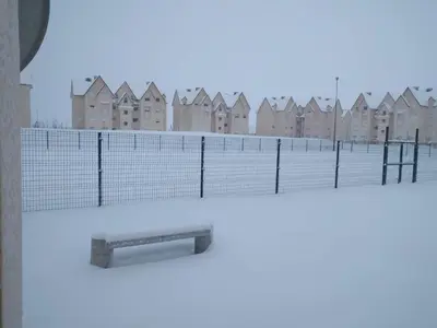a fence with a view of a city at Les jardins d'Ifrane in Ifrane