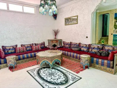 a living room with a couch and a table at Appartement Prestige Kebibat - Charme marocain in Oulad Akkou