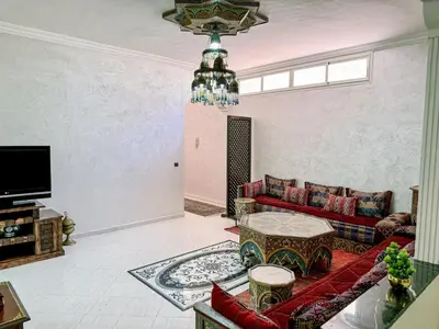 a living room with a couch and a table at Appartement Prestige Kebibat - Charme marocain in Oulad Akkou