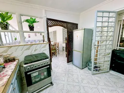 a kitchen with a stove and a refrigerator at Appartement Prestige Kebibat - Charme marocain in Oulad Akkou