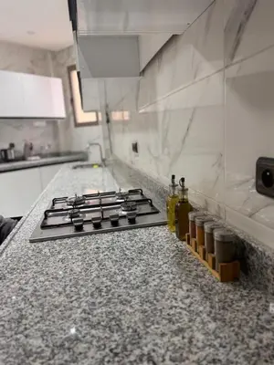 a kitchen counter with a stove top in a kitchen at Appartement Calme & Moderne in Meknès