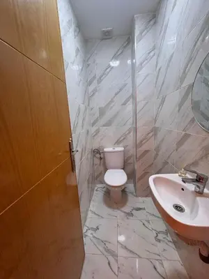 a bathroom with a toilet and a sink at Appartement Calme & Moderne in Meknès