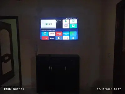 a flat screen tv hanging on a wall at App luxe riad zitoune in Meknès
