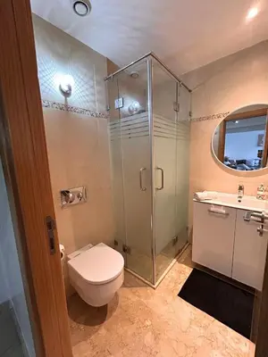 a bathroom with a shower and a toilet and a sink at Elegant cocoon-private pool Bouskoura Green City in Oulad Akkou