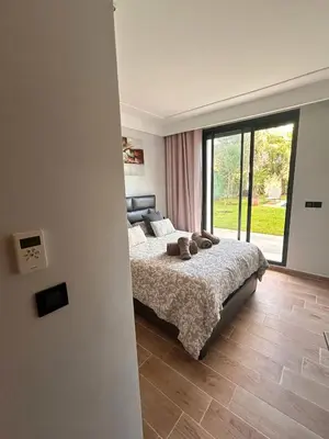 a bedroom with a bed and a large window at Elegant cocoon-private pool Bouskoura Green City in Oulad Akkou