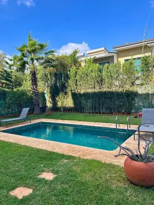 a swimming pool in the yard of a house at Elegant cocoon-private pool Bouskoura Green City in Oulad Akkou