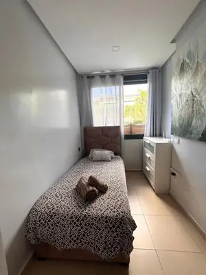 a small bedroom with a bed and a window at Elegant cocoon-private pool Bouskoura Green City in Oulad Akkou