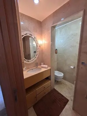 a bathroom with a sink and a mirror and a toilet at Elegant cocoon-private pool Bouskoura Green City in Oulad Akkou