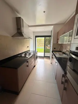 a kitchen with a sink and a stove top oven at Elegant cocoon-private pool Bouskoura Green City in Oulad Akkou