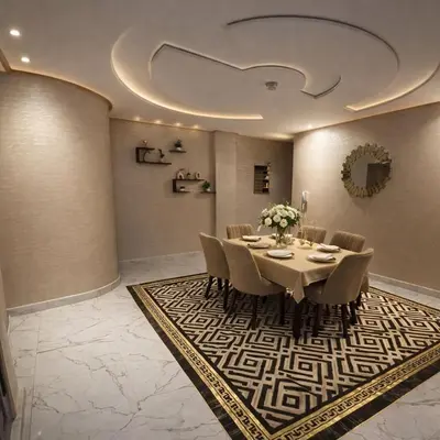 a dining room with a table and chairs on a rug at Prime stay downtown Meknes in Meknès