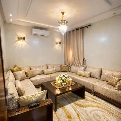 a living room with a large couch and a table at Prime stay downtown Meknes in Meknès