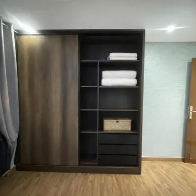 a book shelf with folded towels in a room at Prime stay downtown Meknes in Meknès