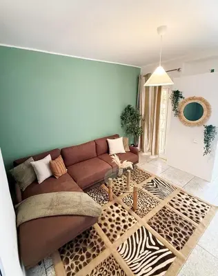 a living room with a brown couch and a rug at 2 bedroom apartment in Meknes-Clim, Wifi & Netflix in Meknès