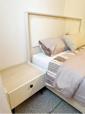 a bedroom with two beds and a night stand at 2 bedroom apartment in Meknes-Clim, Wifi & Netflix in Meknès