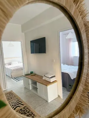 a room with a mirror and a bed and a television at 2 bedroom apartment in Meknes-Clim, Wifi & Netflix in Meknès