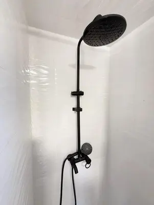 a shower in a bathroom with a ceiling fan at 2 bedroom apartment in Meknes-Clim, Wifi & Netflix in Meknès