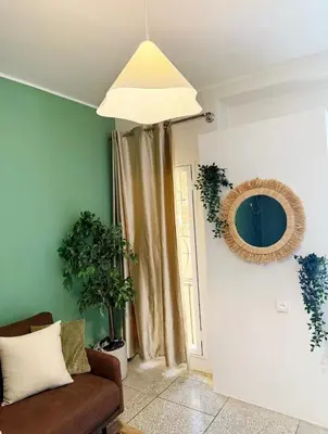 a living room with a couch and a mirror at 2 bedroom apartment in Meknes-Clim, Wifi & Netflix in Meknès