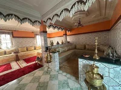 a living room with a couch and a table at Dar Dyafa in Marrakech 5 minutes from the Airport in Oulad Akkou
