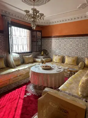 a living room with a couch and a table at Dar Dyafa in Marrakech 5 minutes from the Airport in Oulad Akkou