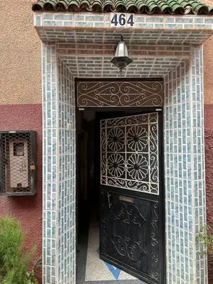 a entrance to a building with a black door at Dar Dyafa in Marrakech 5 minutes from the Airport in Oulad Akkou