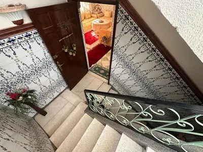 an overhead view of a staircase with a door and a mirror at Dar Dyafa in Marrakech 5 minutes from the Airport in Oulad Akkou