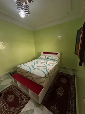 a bedroom with a bed in a room with green walls at Dar Dyafa in Marrakech 5 minutes from the Airport in Oulad Akkou