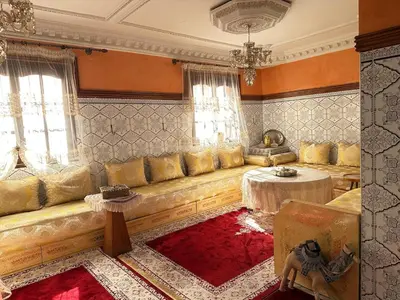 a living room with a large couch and a table at Dar Dyafa in Marrakech 5 minutes from the Airport in Oulad Akkou