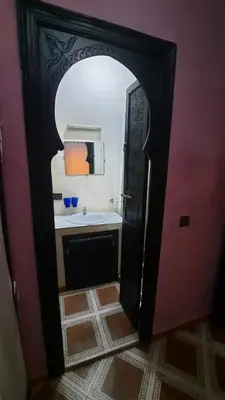 a bathroom with a sink and a mirror at Riad Des Artistes in Oulad Akkou