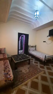 a living room with a couch and a coffee table at Riad Des Artistes in Oulad Akkou
