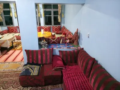 a living room with a couch in a room at skoura in Oulad el Guern