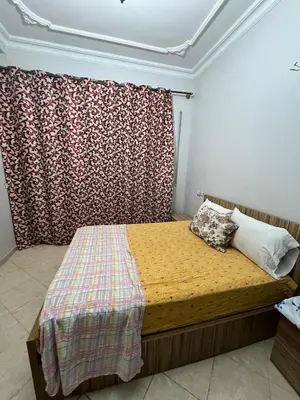 a bed in a room with a curtain and a bed sidx sidx sidx at OFPPT Otmania in Meknès