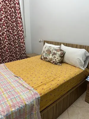 a bed with two pillows on top of it at OFPPT Otmania in Meknès